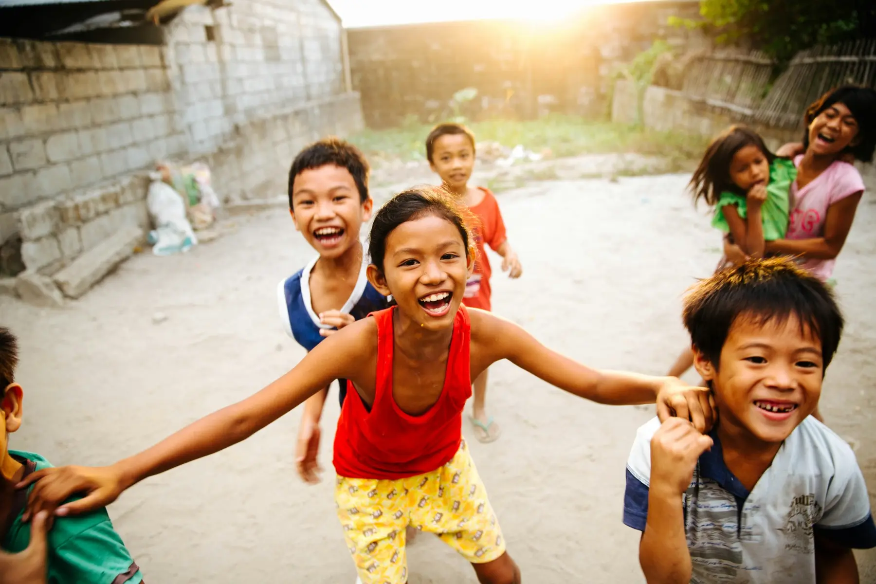 Children smiling and playing outdoors in the Philippines